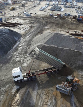 Aggregates containing glass from incinerator bottom ash being delivered to a concrete mixing plant